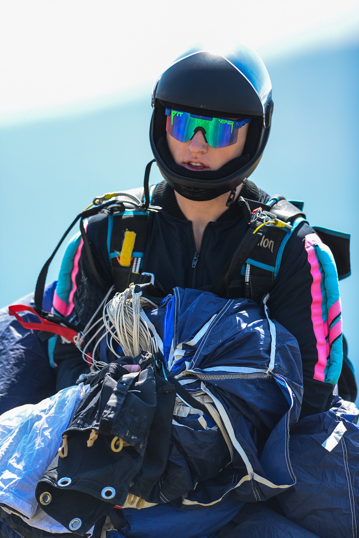 A skydiver carries his parachute and gear after a jump at the 2021 Skydive Lost Prairie Boogie at Meadow Peak Skydiving near Marion on Thursday, Aug. 12, 2021. (Casey Kreider/Daily Inter Lake)