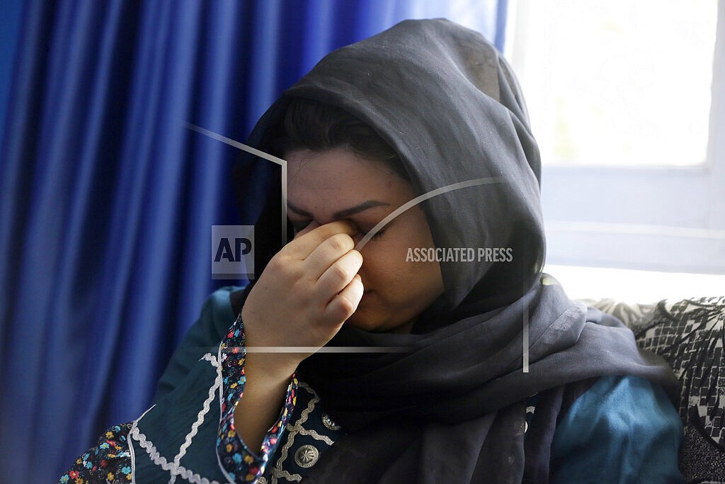 Zarmina Kakar a women's rights activist cry during an interview with The Associated Press in Kabul, Afghanistan, Friday, Aug. 13, 2021. Kakar was a year old when the Taliban entered Kabul the first time in 1996, and recalled a time when her mother took her out to buy her ice cream, back when the Taliban ruled. Her mother was whipped by a Taliban fighter for revealing her face for a couple of minutes. “Today again, I feel that if Taliban come to power, we will return back to the same dark days,” she said.(AP Photo/Mariam Zuhaib)