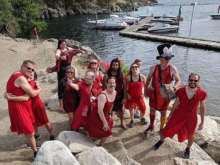 Participants in the 2019 Red Dress Run take a swim in Lake Coeur d'Alene on their stop at Tubbs Hill during a hound and hares chase following clues on a pub crawl through bars in downtown Coeur d'Alene. Courtesy photo