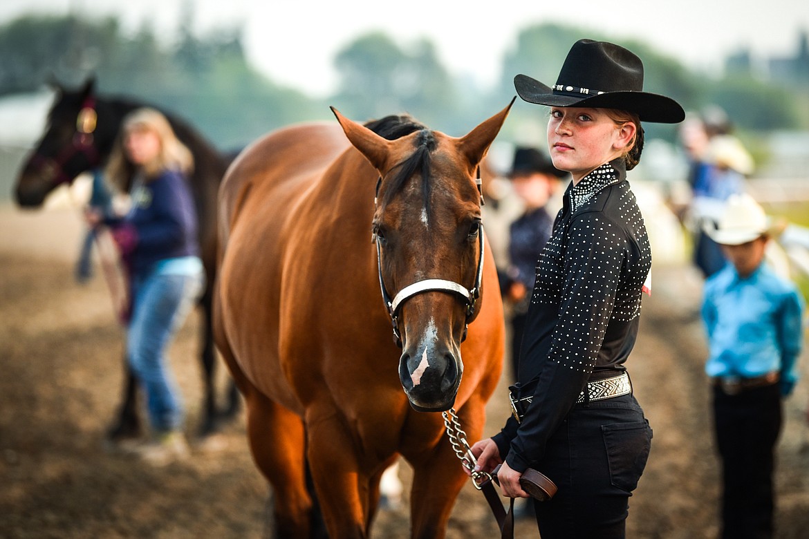 Mia Guffin stands with her horse Ivy before the start of junior level Showmanship at the 4-H Horse Show at the Northwest Montana Fair on Saturday, Aug. 14. (Casey Kreider/Daily Inter Lake)