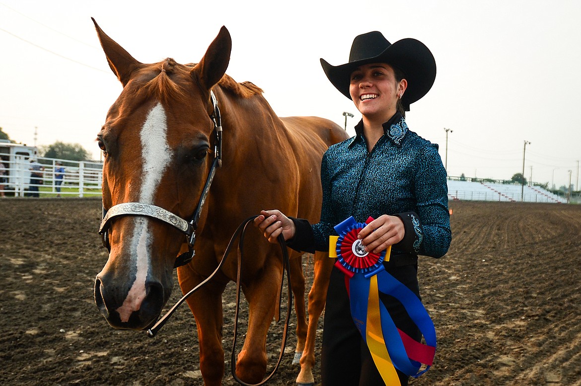 Anna Tretter smiles after receiving her first place ribbon in senior level Showmanship at the 4-H Horse Show at the Northwest Montana Fair on Saturday, Aug. 14. (Casey Kreider/Daily Inter Lake)