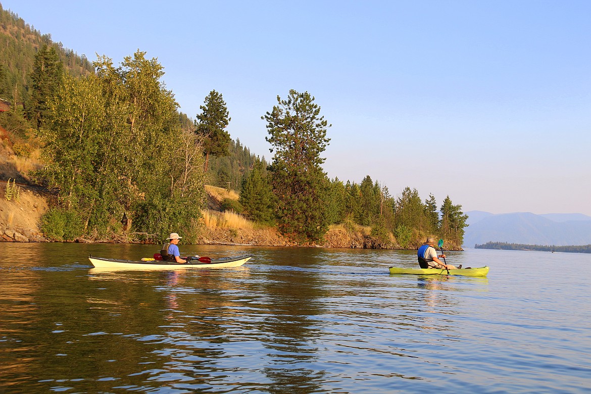 A sea kayak is pictured at left and a sit-on-top kayak is pictured at right.