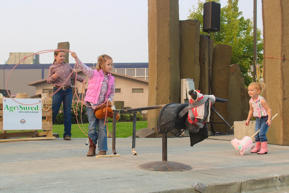 Shaye Cobb ropes a metal bull at the Cowboy Breakfast peewee rodeo Friday morning.