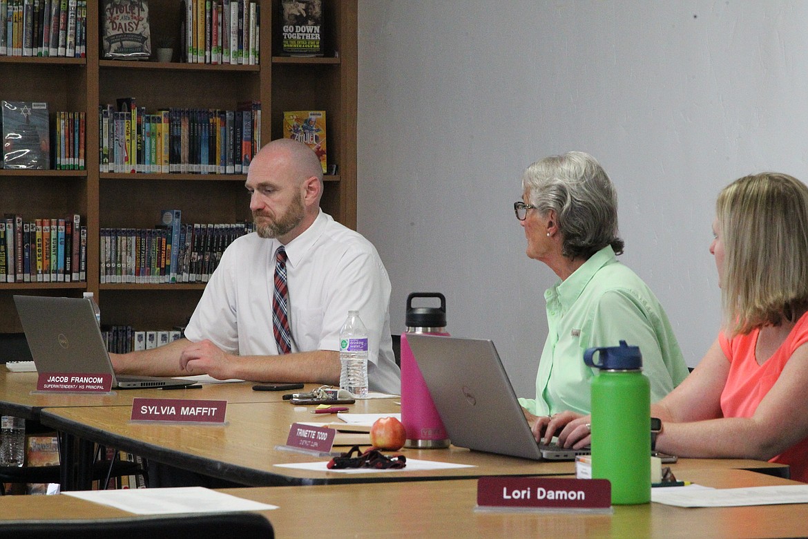 Troy Superintendent Jacob Francom, left, Board Chair Sylvia Maffit, center,  and District Clerk Trinette Todd review school policies during an Aug. 12 school board meeting. Masks will be optional for Troy students when they return to classrooms later this month. (Will Langhorne/The Western News)