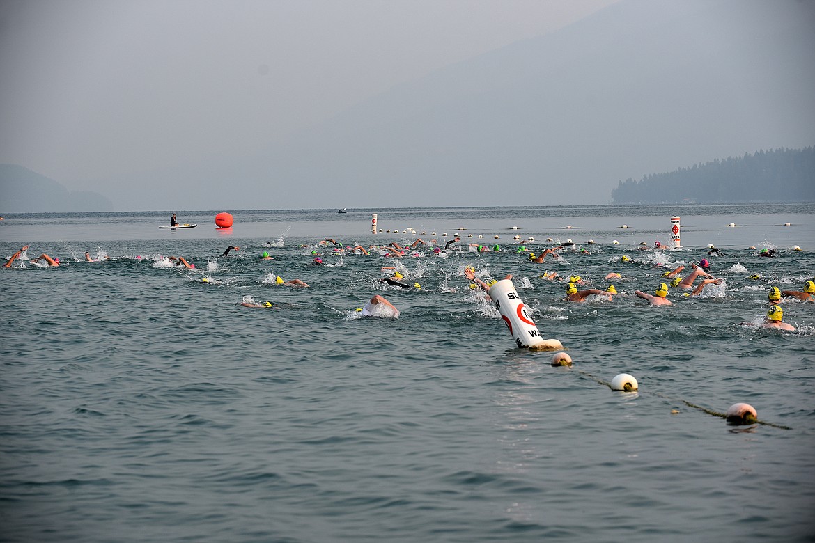 Swimmers begin the Swim the Fish race on Saturday morning in Whitefish Lake. (Heidi Desch/Whitefish Pilot)