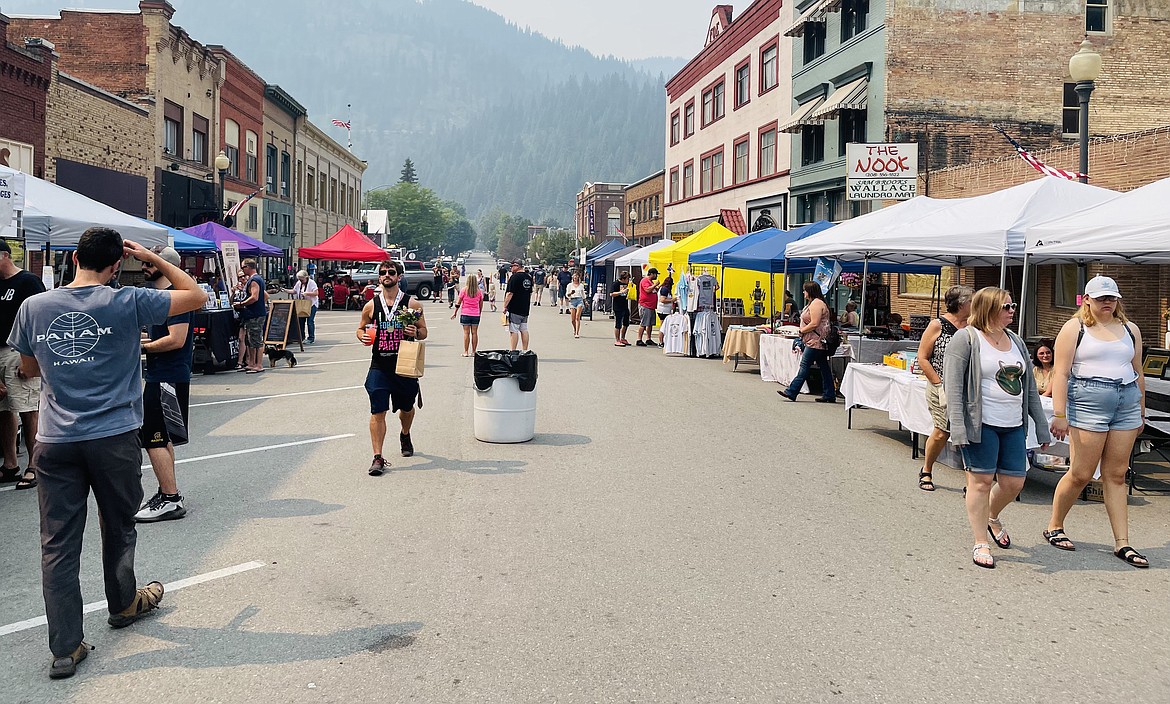 Visitors make their way through the throng of vendors, each peddling their unique wares to the delight of the festival goers on Cedar Street.