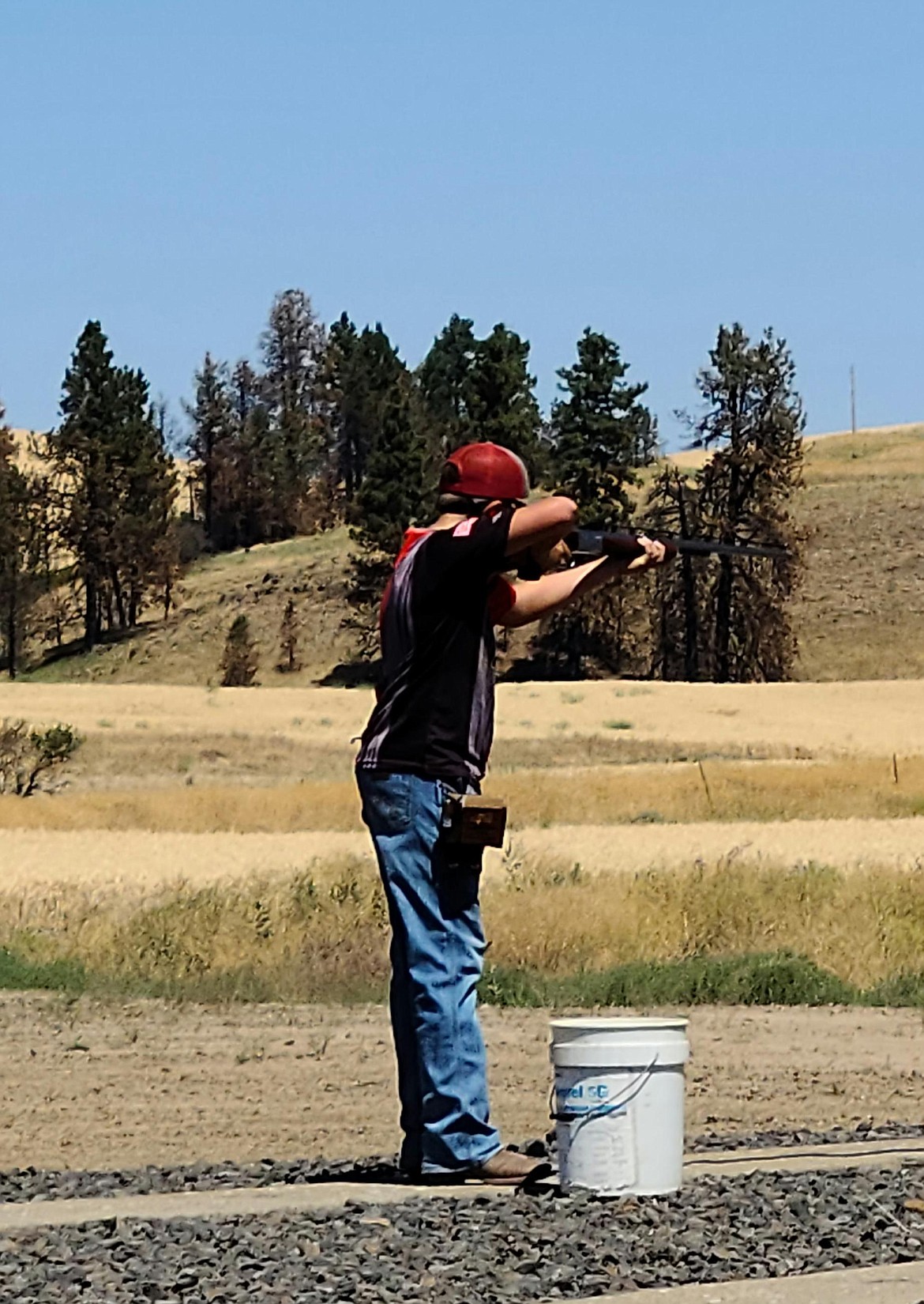 Travis Shearer takes aim at a clay pigeon during a trapshooting competition in July.