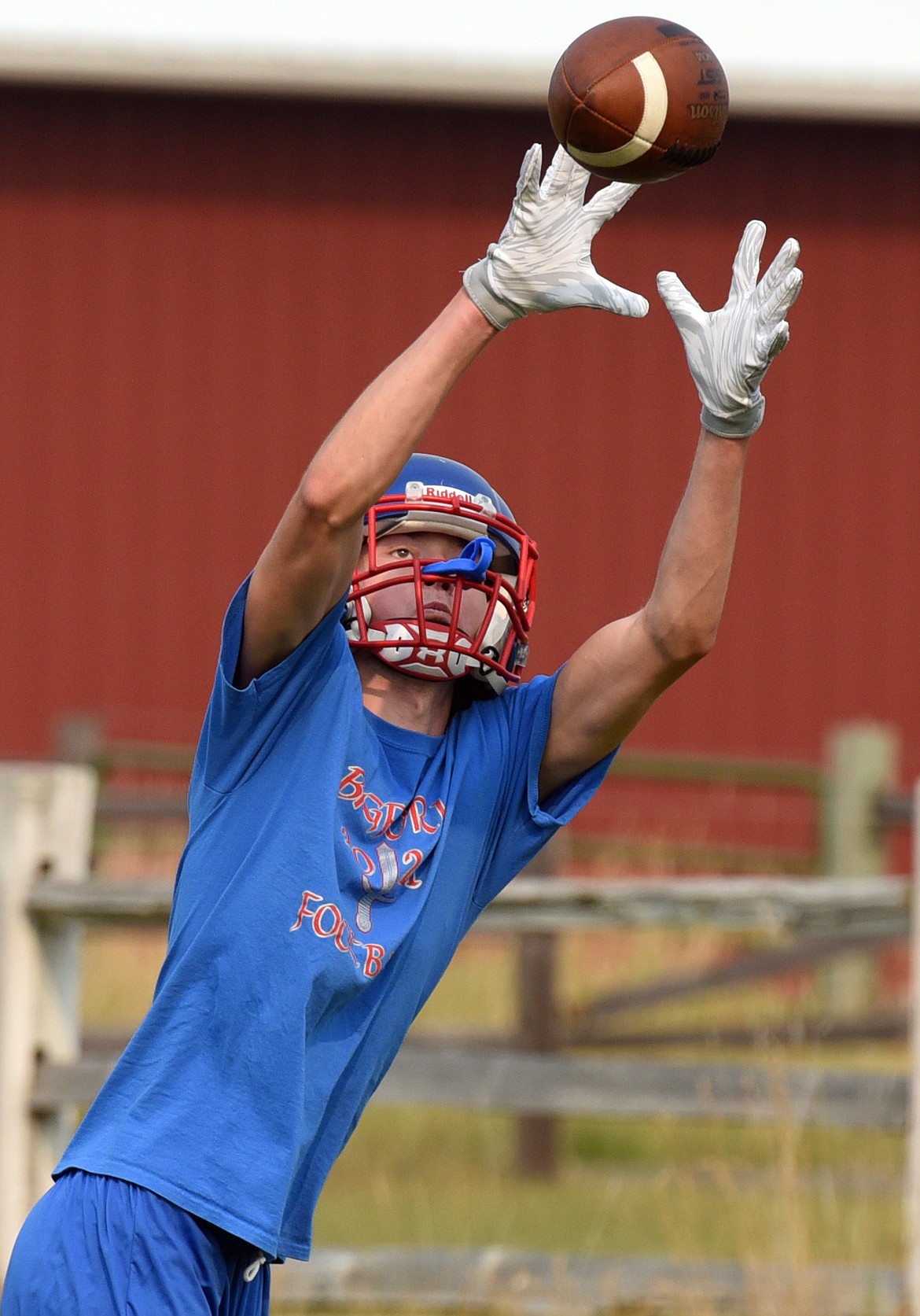 Isak Epperly goes up to catch a pass during Vikings football practice Friday. (Jeremy Weber/Bigfork Eagle)