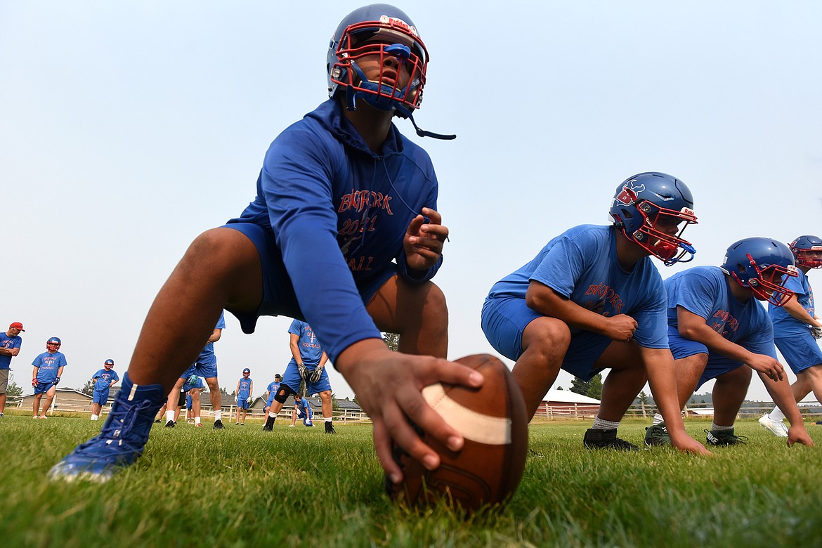 George Brown prepares to hike the ball during Vikings football practice Friday. Brown and the majority of last season’s offensive line will be back in 2021. (Jeremy Weber/Bigfork Eagle)