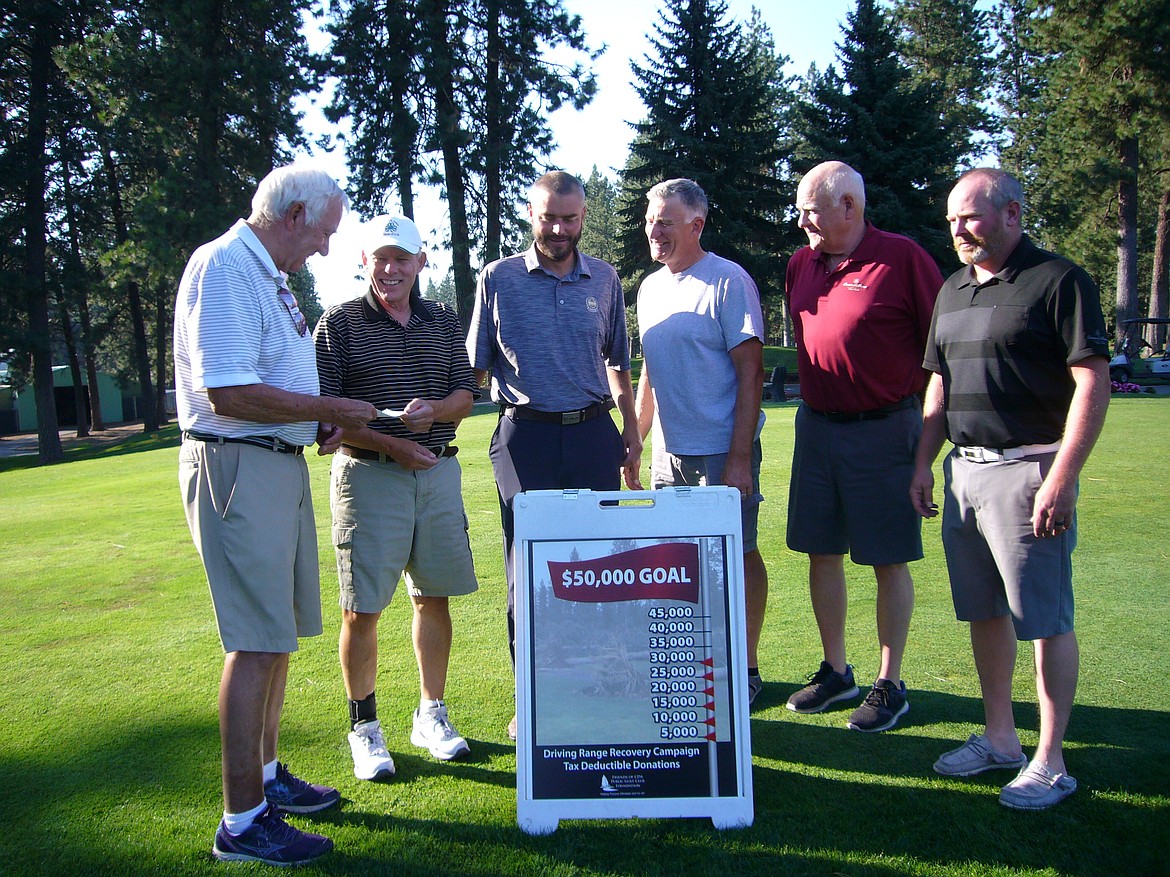 John Adams, left, chairman of the Friends Foundation's January Wind Storm Recovery Campaign, presents a check for $29,293 to Craig Paterson, president of the Coeur d'Alene Golf Club. Looking on is PGA professional Brent Walsh, third from left; Paul Hill, vice president of the Coeur d'Alene Golf Club board of directors; Dave Patser, Friends Foundation president; and golf course superintendent Brandon Bubar. "And I just got another $150, so now we're at $29,443," said Ken Catalano, vice president of the Friends Foundation. The money goes to the golf course, to help offset expenses incurred from the January windstorm — the difference between the amount of money needed to repair the damage, and the amount coming from the insurance company, represented a shortfall of some $43,000. The foundation sent out more than 500 direct-mail pieces to folks who lived near the golf course, and 4,026 emails to people who had played the course and left their email addresses. "We've had responses from Canada, the East Coast, a couple organizations in Chicago," Catalano said. "It's been pretty dag-gone phenomenal; I am really impressed."