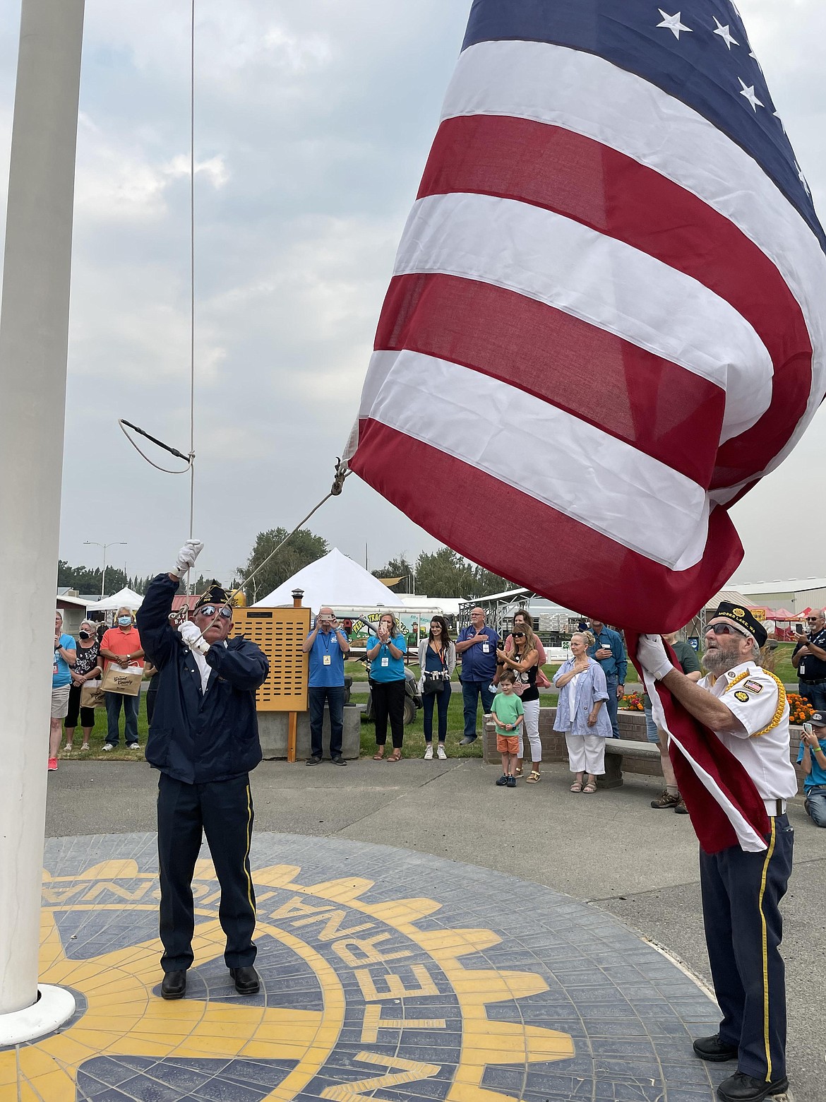 Two members of the Moses Lake American Legion Post 209 raise the flag at the opening ceremony of this year’s Grant County Fair on Tuesday.