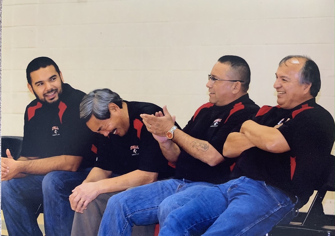 Left to right, Rudy Ochoa II, Mark Kondo, Danny Gonzales and Ruben Martinez share a laugh on the sidelines of an Othello High School wrestling match.