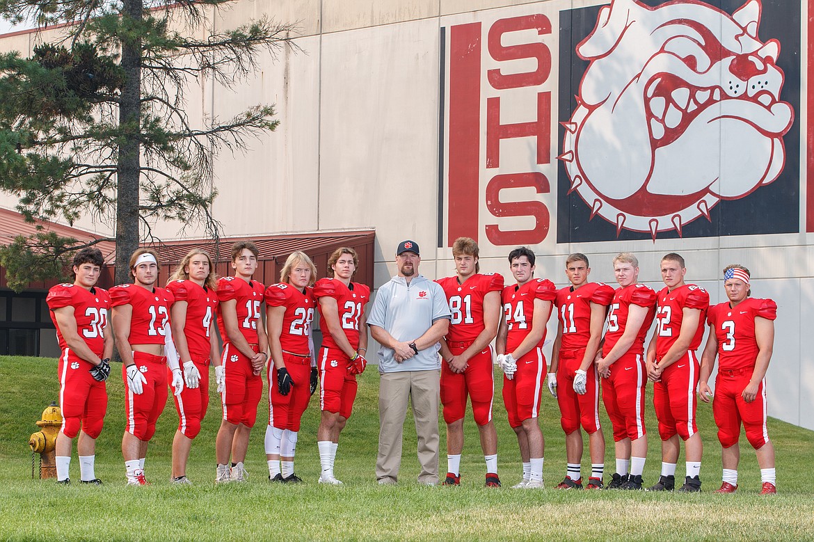 The Sandpoint football team will be led by a group of 12 seniors this fall. Pictured (from left): Dakota Wilson, Gerrit Cox, Merek Bauck, Cody Steiger, Layne Dunkel, Luke McCorkle, head coach Ryan Knowles, Will Hurst, Nathan Robere, Lasse Kuhn, Nate Blagrove, Mike Chapman and Blake Sherrill.