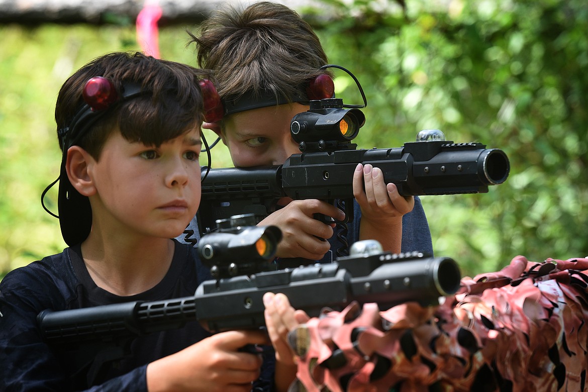 Rafferty Bunn, left, and Sam Collins pick their targets while playing with Flashpoint Outdoor Laser Tag near Bigfork on Friday, Aug. 10, 2021. (Jeremy Weber/Daily Inter Lake)