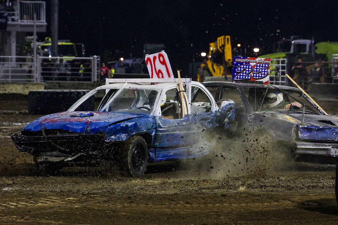 Sean McCullough, 269, backs into Christopher Weber, 25, in the compact car demolition derby Tuesday night at the Grant County Fairgrounds.