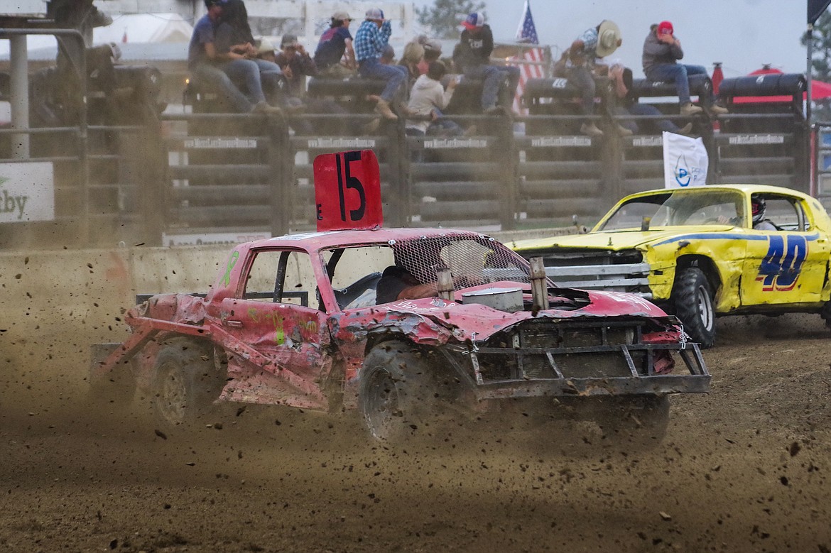 Brian Melbye, No. 15, makes his way around the dirt track at the Grant County Fairgrounds Tuesday night in the Northwest Ag Demolition Derby.