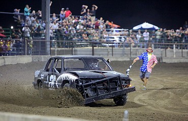 Josiah Guerra (126) holds his hand out of the window after taking first place in an Australian Pursuit event on Wednesday night at the Northwest Ag Demolition Derby.