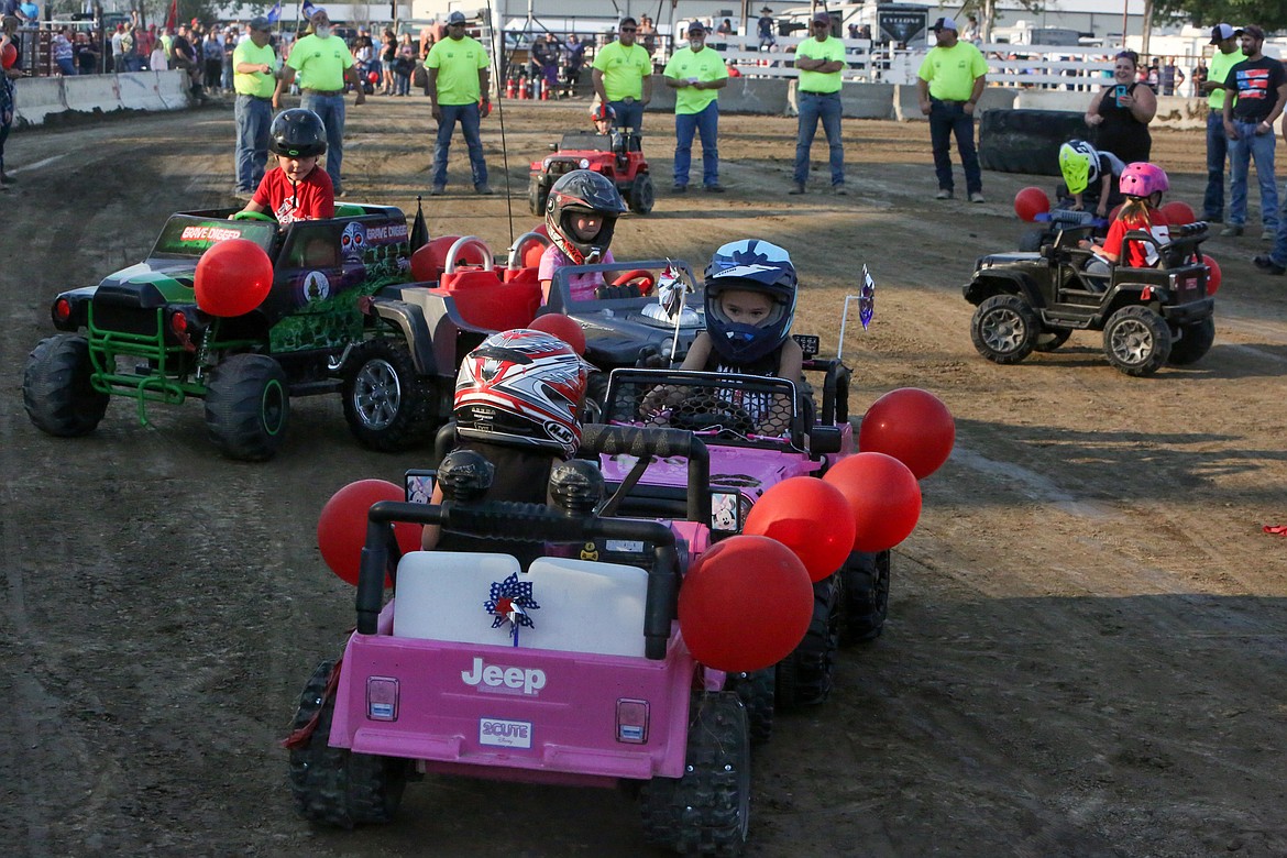 Young riders bump and battle in the Youth Power Wheels Demo event at the start of the Northwest Ag Demolition Derby on Wednesday night.