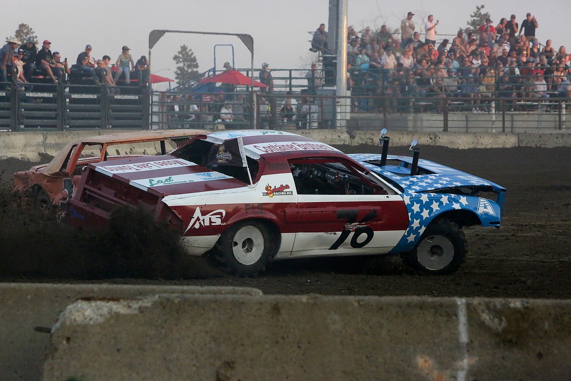 Drivers collide rounding the corner during a heat race at the Northwest Ag Demolition Derby on Wednesday night.