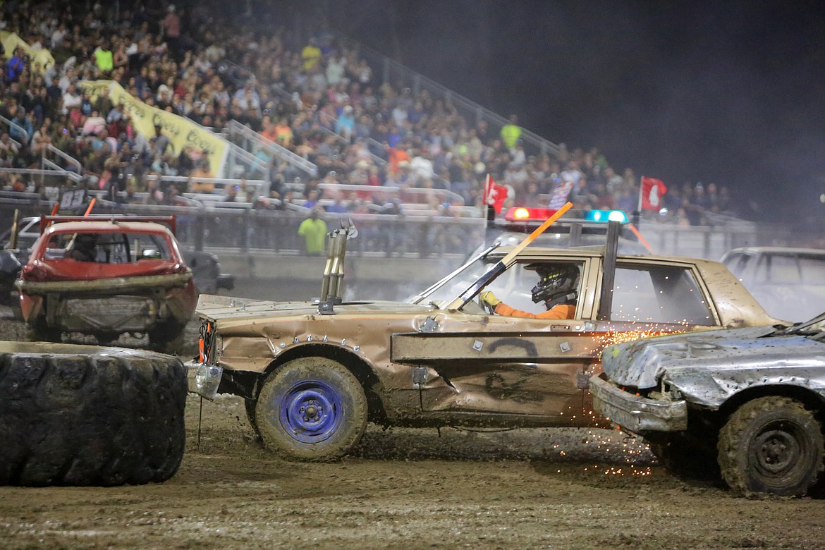 Sparks fly as cars collide during the demolition derby event to cap off the night on Wednesday at the Northwest Ag Demolition Derby.