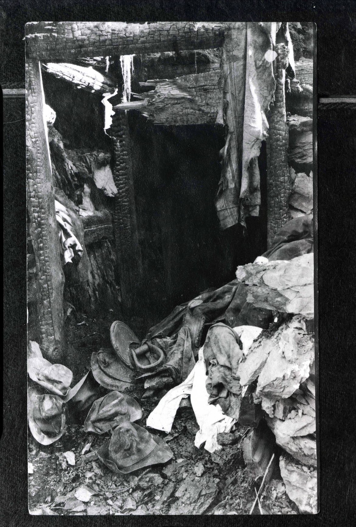 The entrance to the mine tunnel that Pulaski and his men survived the fire in. There is a saddle, a hat and discarded clothing in front of the tunnel.