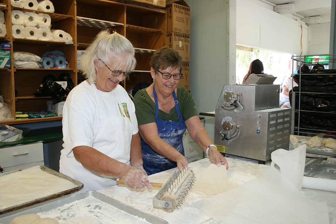 Volunteers Susan Hickok (left) and Mary Heston (right) make lion ears at the Moses Lake Lions Club food booth Tuesday during the Grant County Fair.