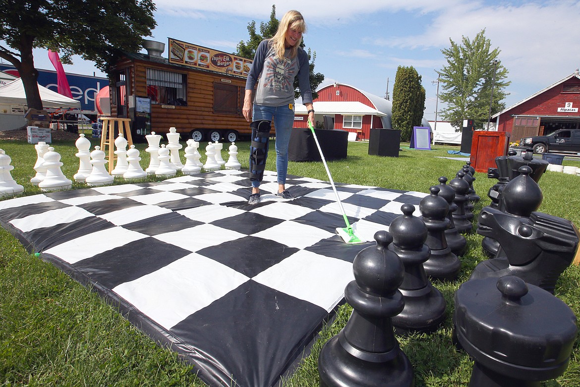 Pam Shultz cleans the chess board Thursday that is part of her Wild Science show that will be at the North Idaho State Fair.