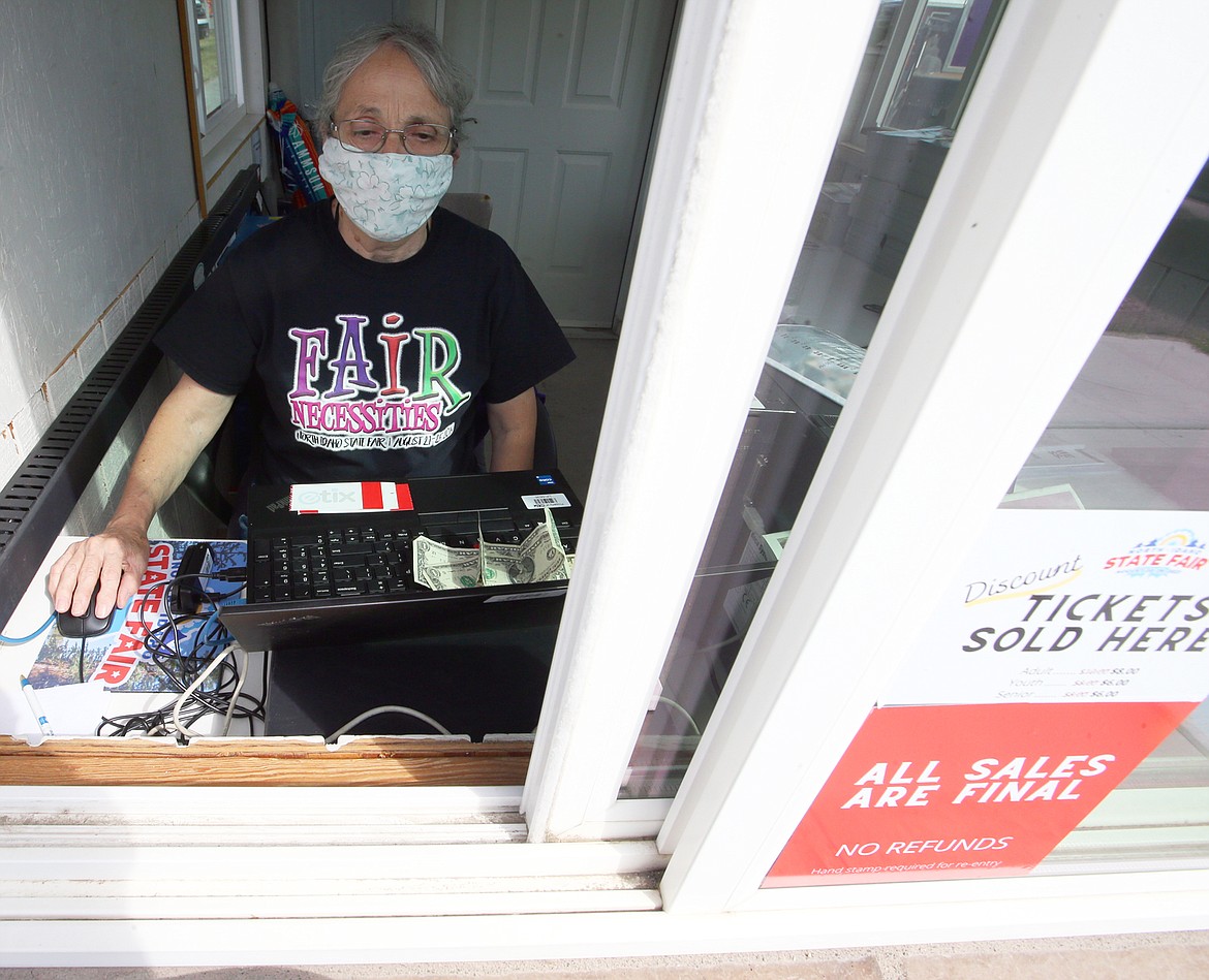 Debbie Stone works at the ticket booth of the North Idaho State Fair on Thursday.