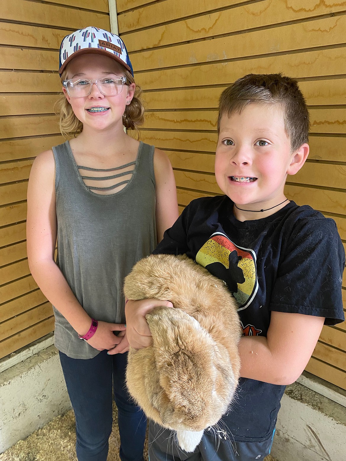 Baylee and Owen Voss holding their lop breed rabbit, Otis