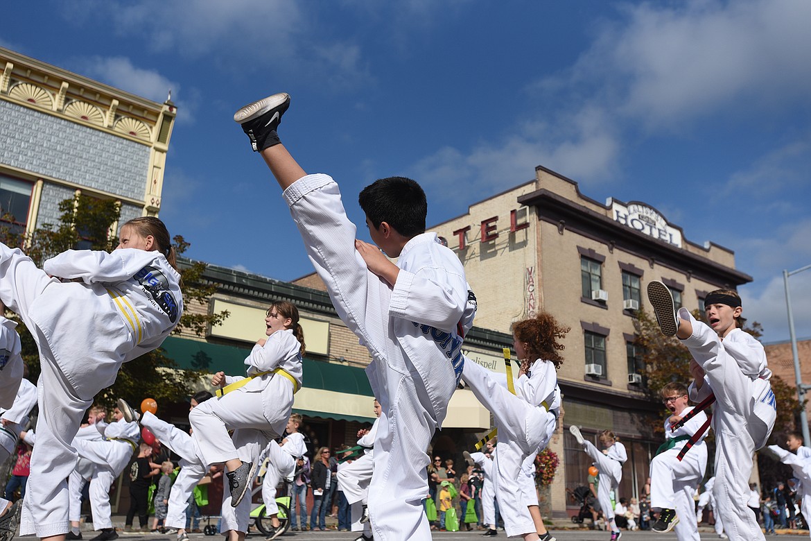 Members of Big Sky Martial Arts show off their skills on Main Street in Kalispell during the Northwest Montana Fair Parade on Friday, Aug. 20. 2021. (Jeremy Weber/Daily Inter Lake)