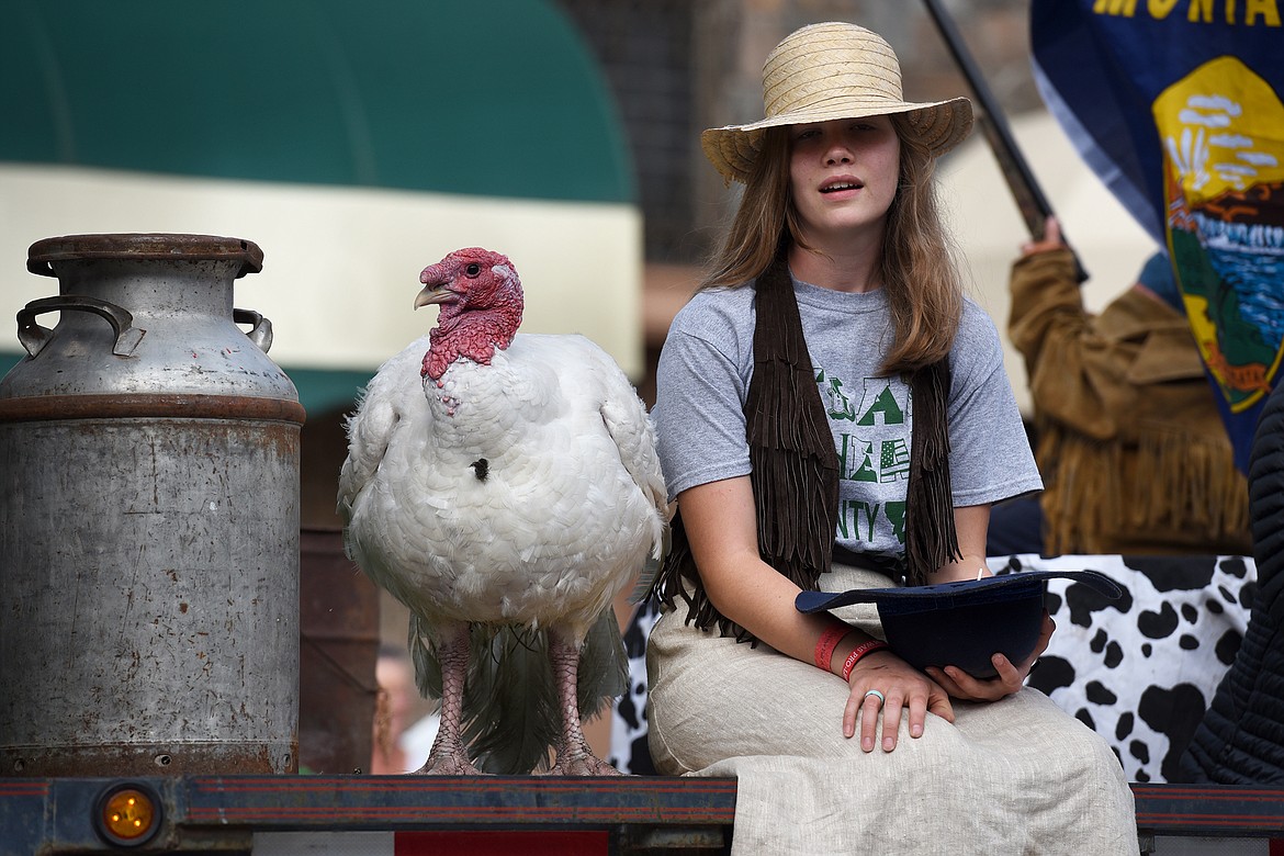 Two riders on a 4-H float, one fair and one fowl, take in the crowd during the Northwest Montana Fair Parade on Main Street in Kalispell on Friday, Aug. 20, 2021. (Jeremy Weber/Daily Inter Lake)