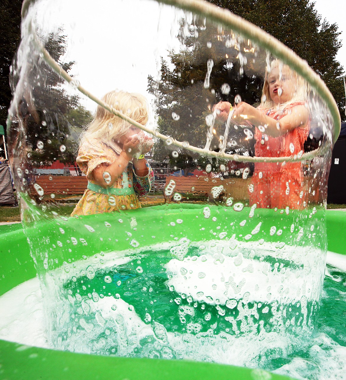 Desi and Charlotte Wagner have fun making giant bubbles at the Wild Science program at the North Idaho State Fair on Friday.