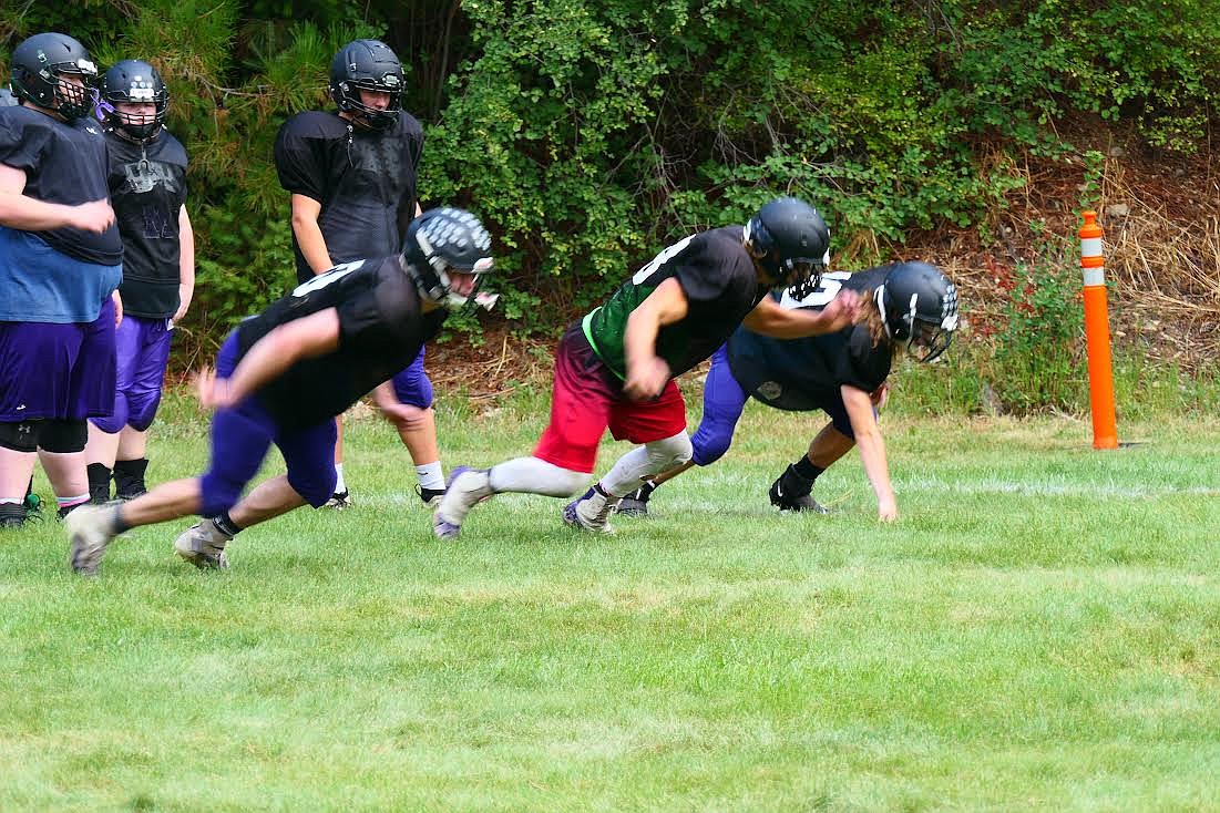 St. Regis/Mullan, Idaho linemen work at getting off the ball quickly during practice on the field in Mullan during a recent practice. (Chuck Bandel/Valley Press)