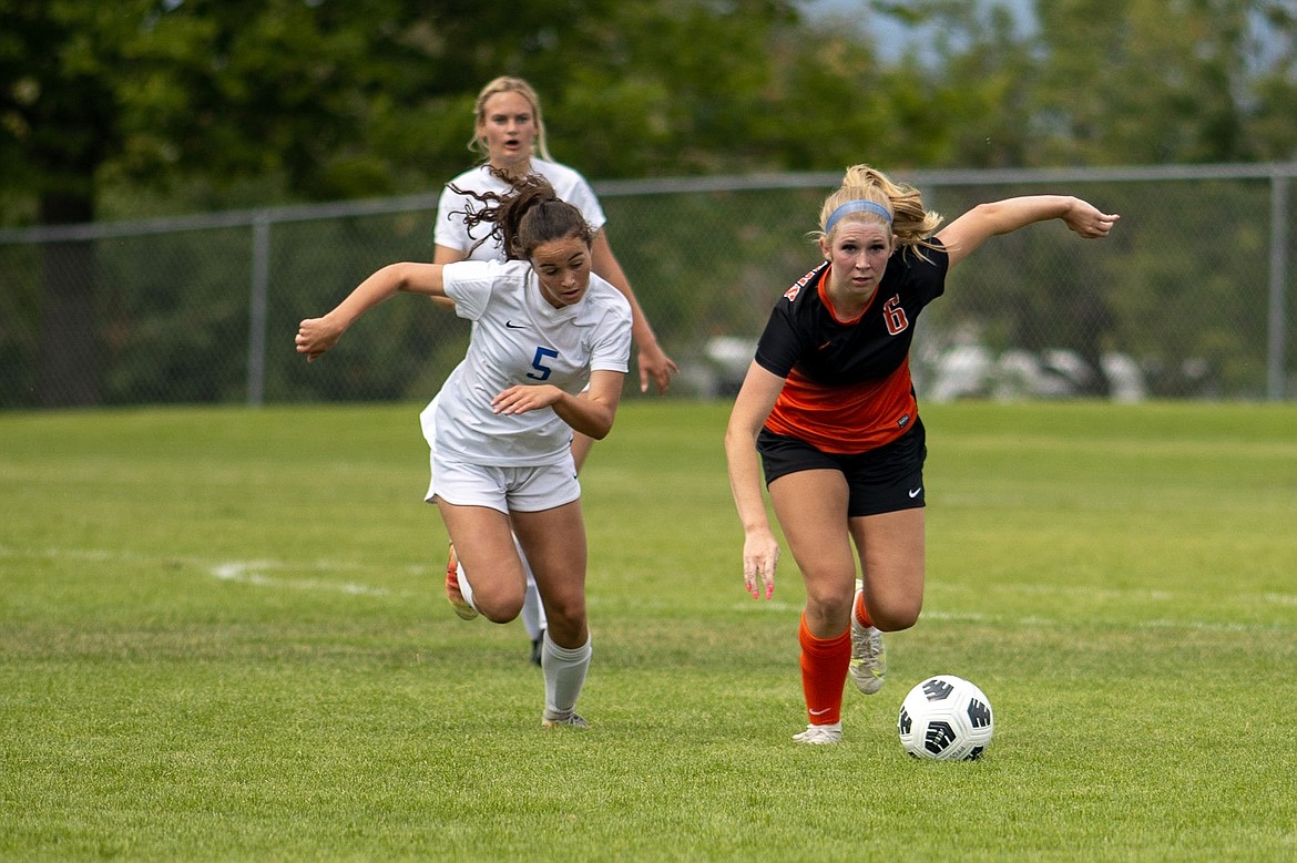 Photo by JERRY VICK
Keaton Delaney (6) of Post Falls maneuvers the ball upfield as Grace Breisacher of Coeur d'Alene pursues on Saturday at Post Falls High.