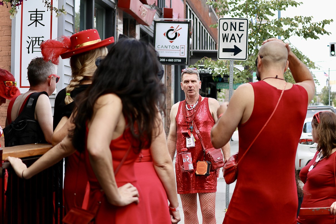 Mark Enegren, facing, founder of the Coeur d’Alene Hash House Harriers chapter, gives instructions to the red dress runners outside of Crown & Thistle Pub on Saturday afternoon. The Red Dress Run is an annual fundraiser, this year raising money for the Kootenai Humane Society. HANNAH NEFF/Press