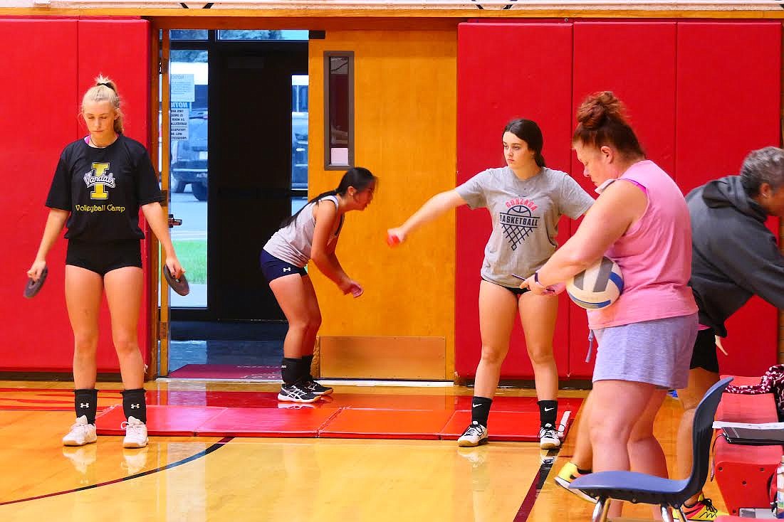 Noxon volleyball coach Dana Grupenhoff (pink shirt) runs her team through weight training and conditioning drills during a recent practice. (Chuck Bandel/Valley Press)