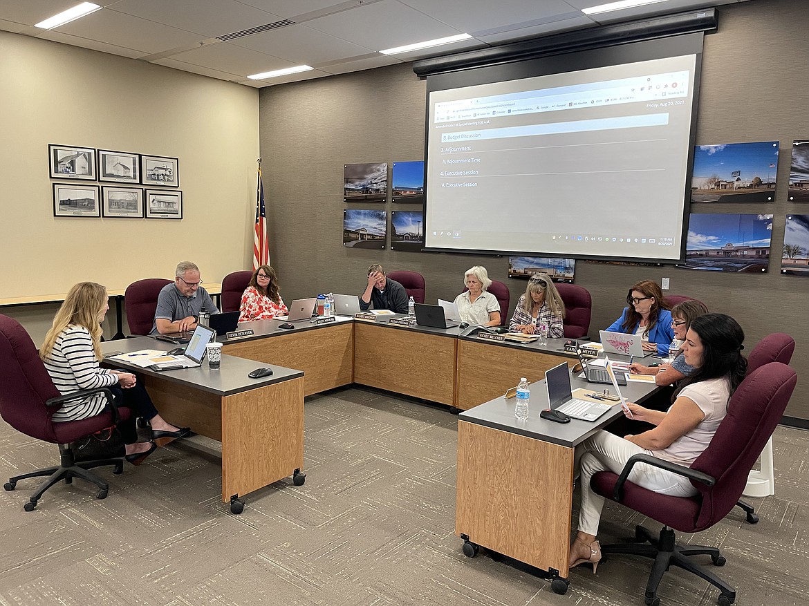 Moses Lake School District Business Manager Stefanie Lowry, at left, outlines possible cuts to the upcoming Moses Lake public schools budget during a special board meeting on Friday.