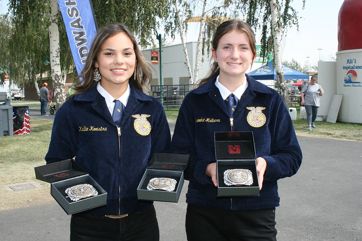 Kallie Kooistra, left, and Brooke Melburn, both of Quincy, show off their Grant County Fair winnings Saturday.