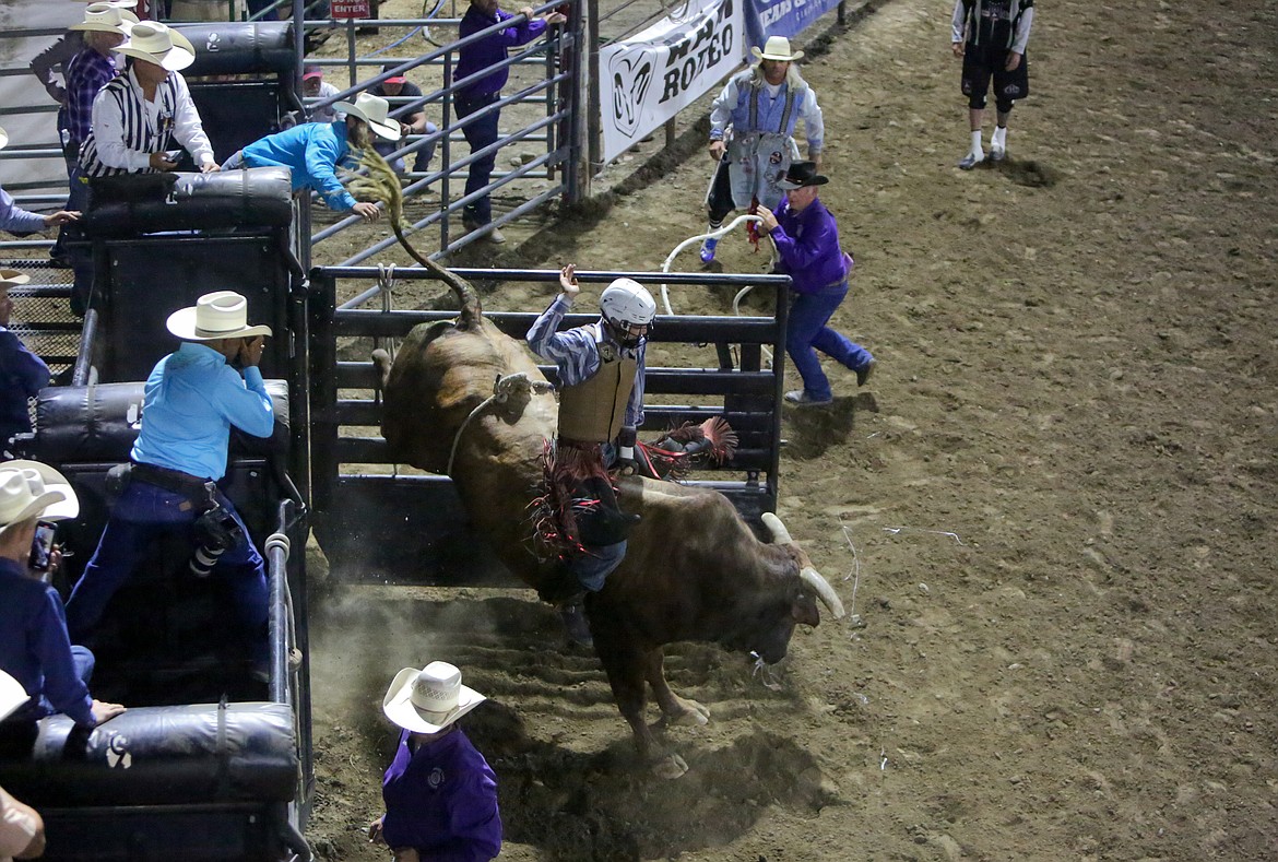 Wyatt Covington of Omak, Washington, does his best to hang on to the bull, Damn Right, during the bull riding event Saturday night at the Moses Lake Roundup Rodeo.