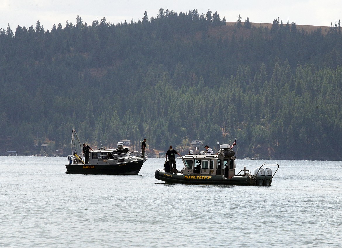 Kootenai County Sheriff's boat cross paths as investigators search for the body of a missing man on Monday just off City Beach.