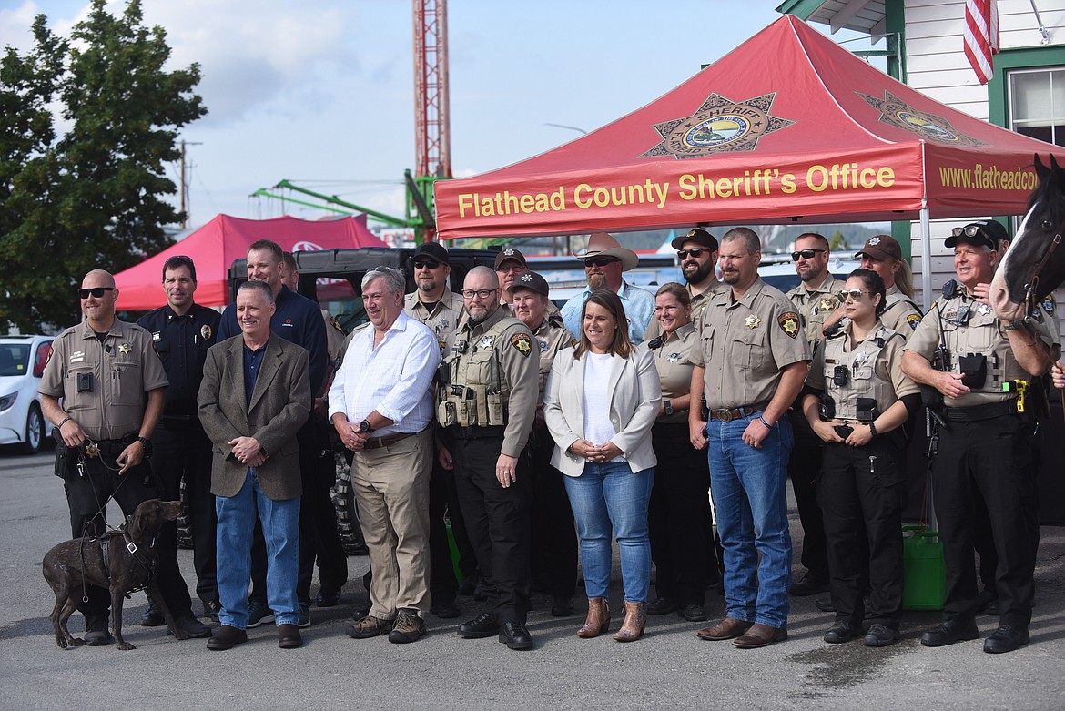 Members of the Flathead County Sheriff's Posse, the county sheriff's office and L3Harris Technologies gather Friday, Aug. 20, 2021, at the Northwest Montana Fair and Rodeo in Kalispell to mark the donation of 65 radios from the Florida-based company. (Scott Shindledecker/Daily Inter Lake)