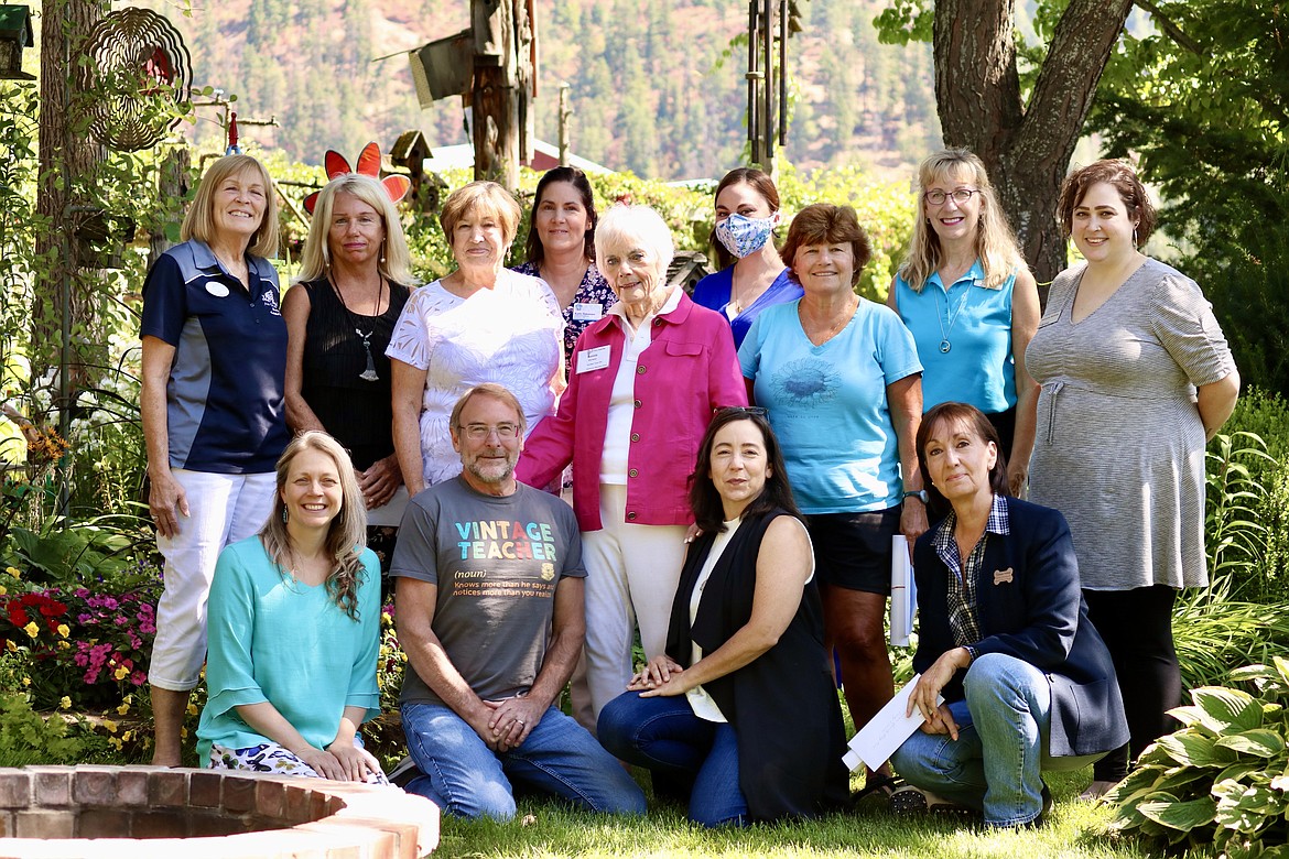 Receivers of the Coeur d'Alene Garden Club donations for 2021. Top row from left: Diane Zell of Silver Angels for the Elderly; Kristin Neeser of Safe Passage; Cathy Evjen, Coeur d'Alene Garden Club co-chair; Katie Simmons of ICARE; Bonnie Warwick, Coeur d'Alene Garden Club co-chair; Mandi Harris of Coeur d'Alene Public Library Foundation Children's Naturebrary; Nickie Odenthal of Second Chance Pet Rescue; Pam Noah of NIC Dual Enrollment; and Annette Nolting of Safe Passage. Kneeling from left: Sherlyn Long of Shared Harvest Garden; Vern Harvey of Hayden Meadows Greenhouse Project; Jenny Supp of Kidscentric Sports Association; and Vicky Nelson of Kootenai Humane Society. Not pictured is John Corcoran of Elder Help. HANNAH NEFF/Press