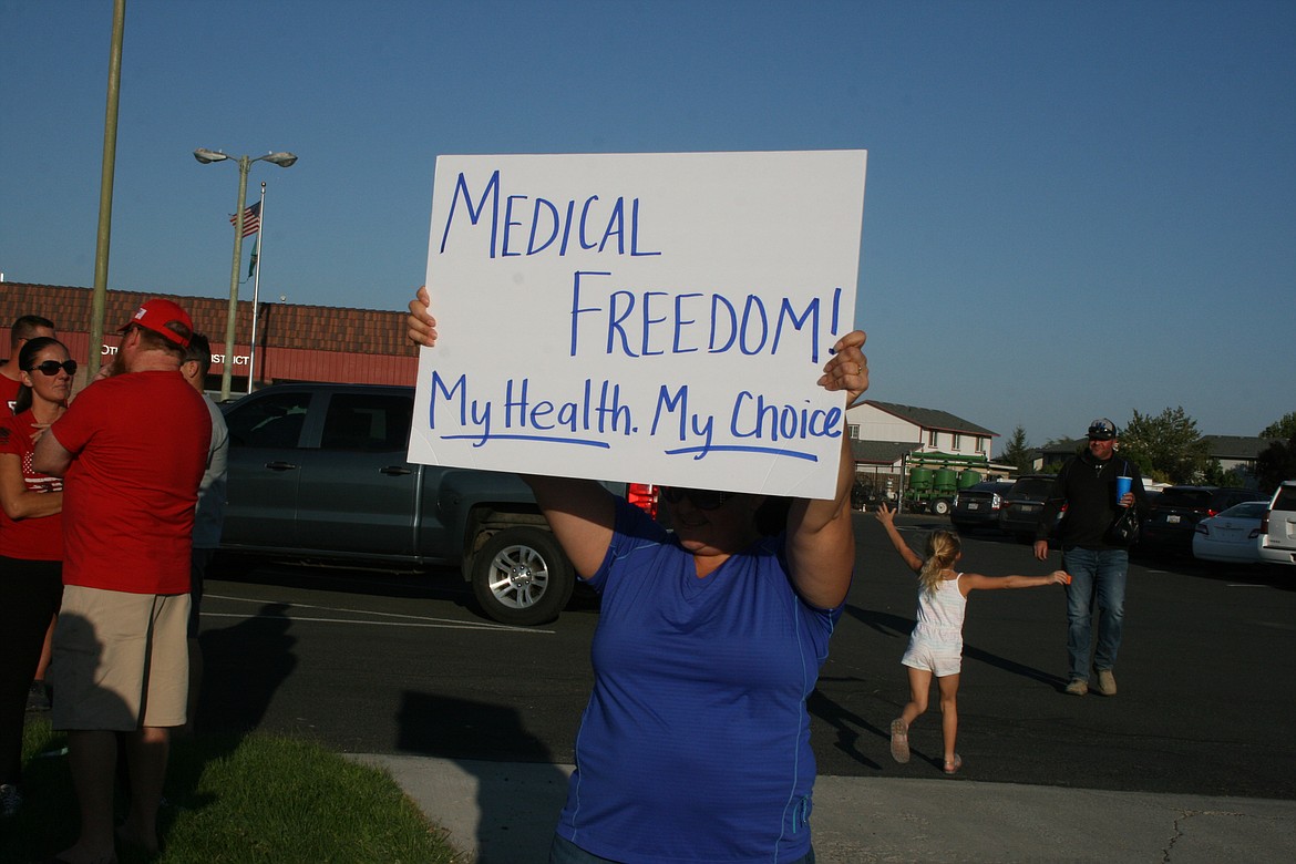 Protesters gathered outside the Othello School District office Monday to protest mandates requiring them to be vaccinated against the COVID-19 virus or risk losing their jobs.