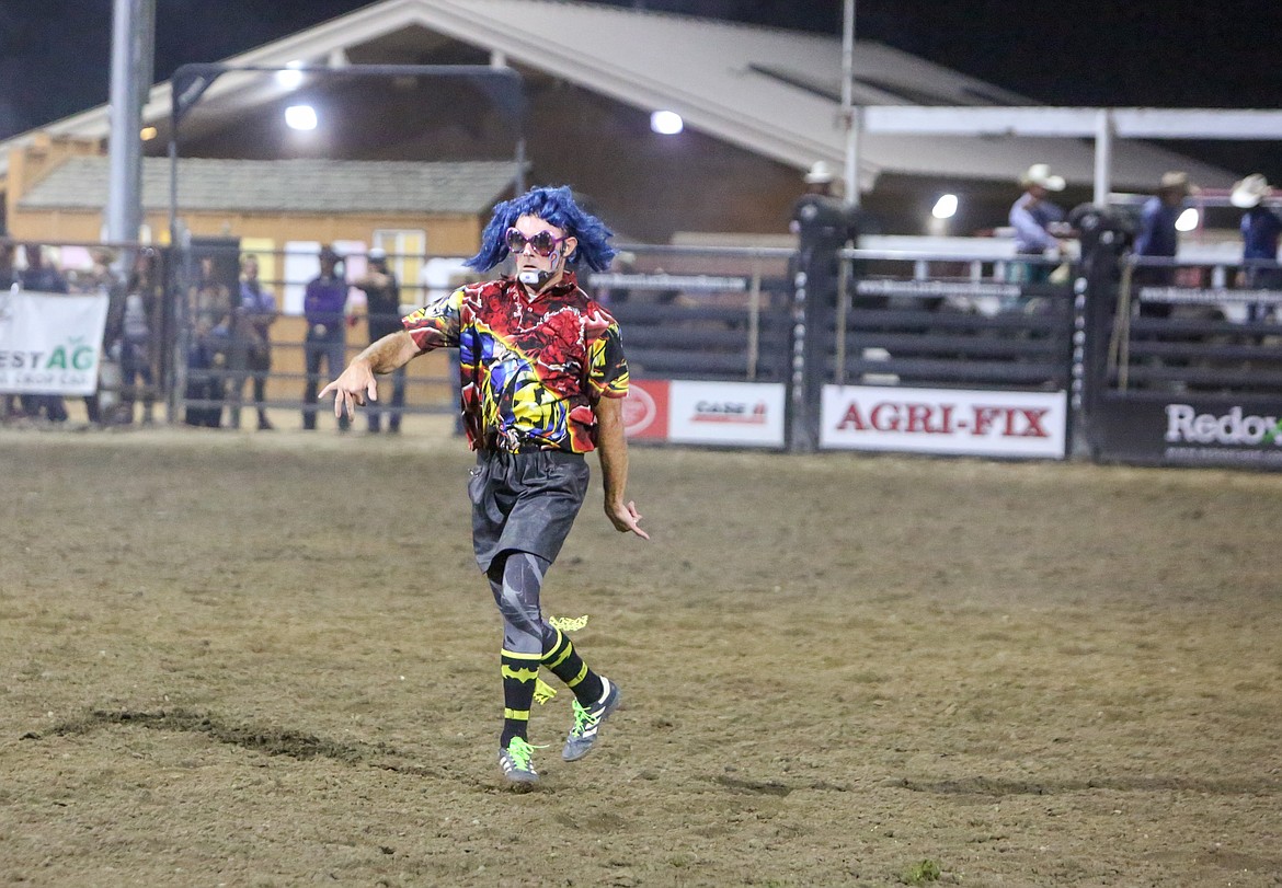 Rodeo clown J.W. Winklepleck dons a wig and star-shaped glasses as he dances to Lady Gaga’s “Bad Romance” entertaining the crowd on Saturday at the Moses Lake Roundup.