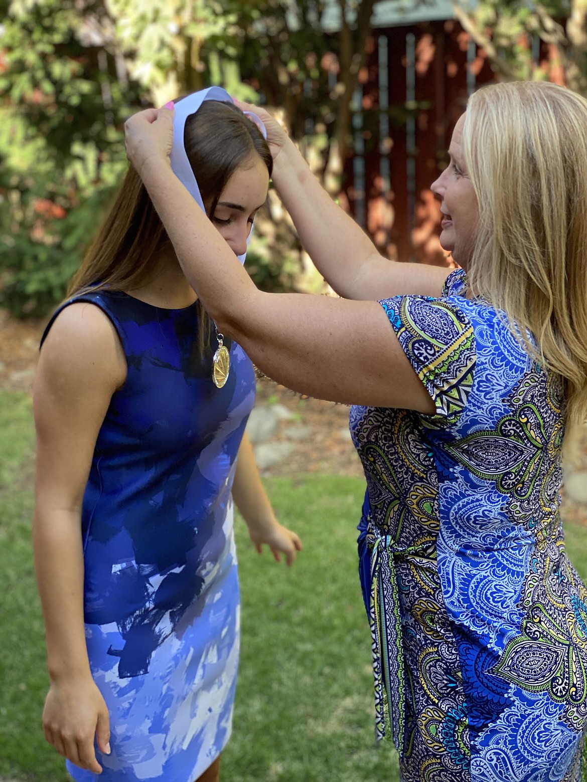 Esther Roeber (left) receives her award as Washington Distinguished Young Woman 2022 from Moses Lake DYW co-chair Jennifer Gaddis (right) on the night of the pageant, Aug. 7.