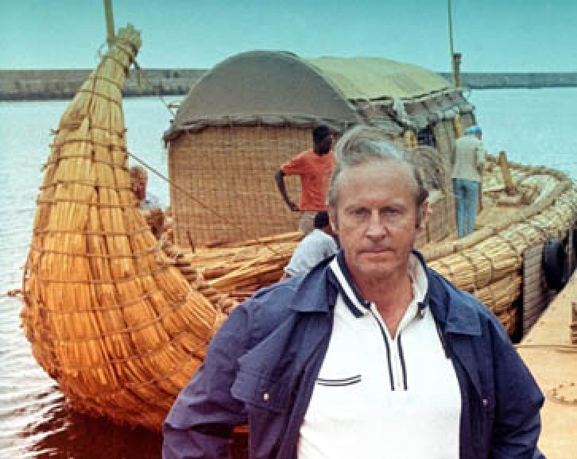 Thor Heyerdahl in front of Ra I, nearing completion for voyage across the Atlantic from Morocco to Barbados (1969).