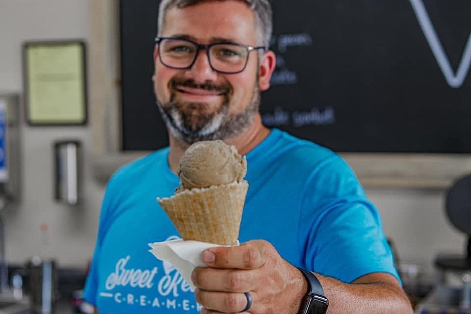 Co-owner Bruce Crockett holds up a scoop of java chip ice cream at the new Sweet Retreat Creamery in Columbia Falls. (Courtesy photo)