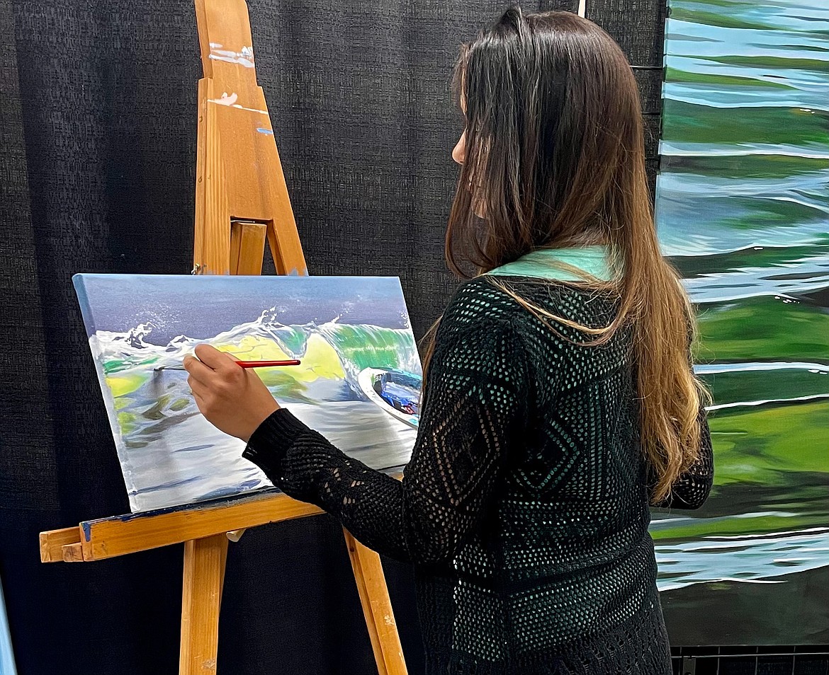 Hannah Fountain paints on her easel at her booth set up in the Commercial Building last week at the Grant County Fair.