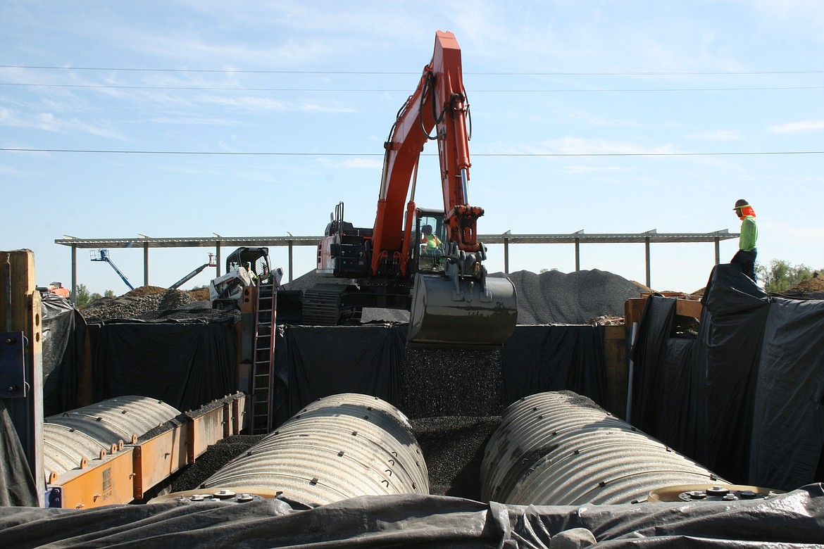 A power shovel dumps rock at the Love’s Travel Stop location just off Interstate 90, on the west side of Moses Lake, Tuesday. Beams for a structure are visible in the background.