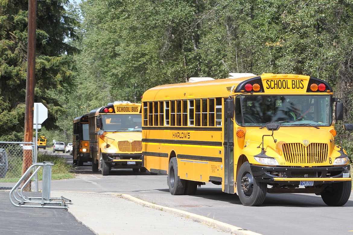 Buses file into the Libby Elementary School parking lot after the first day of classes on Aug. 25. (Will Langhorne/The Western News)